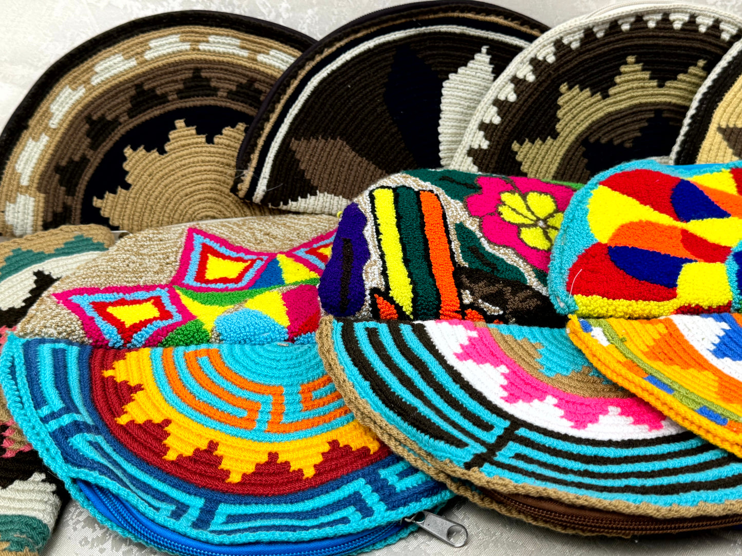 Colorful woven bags with geometric patterns on a light background