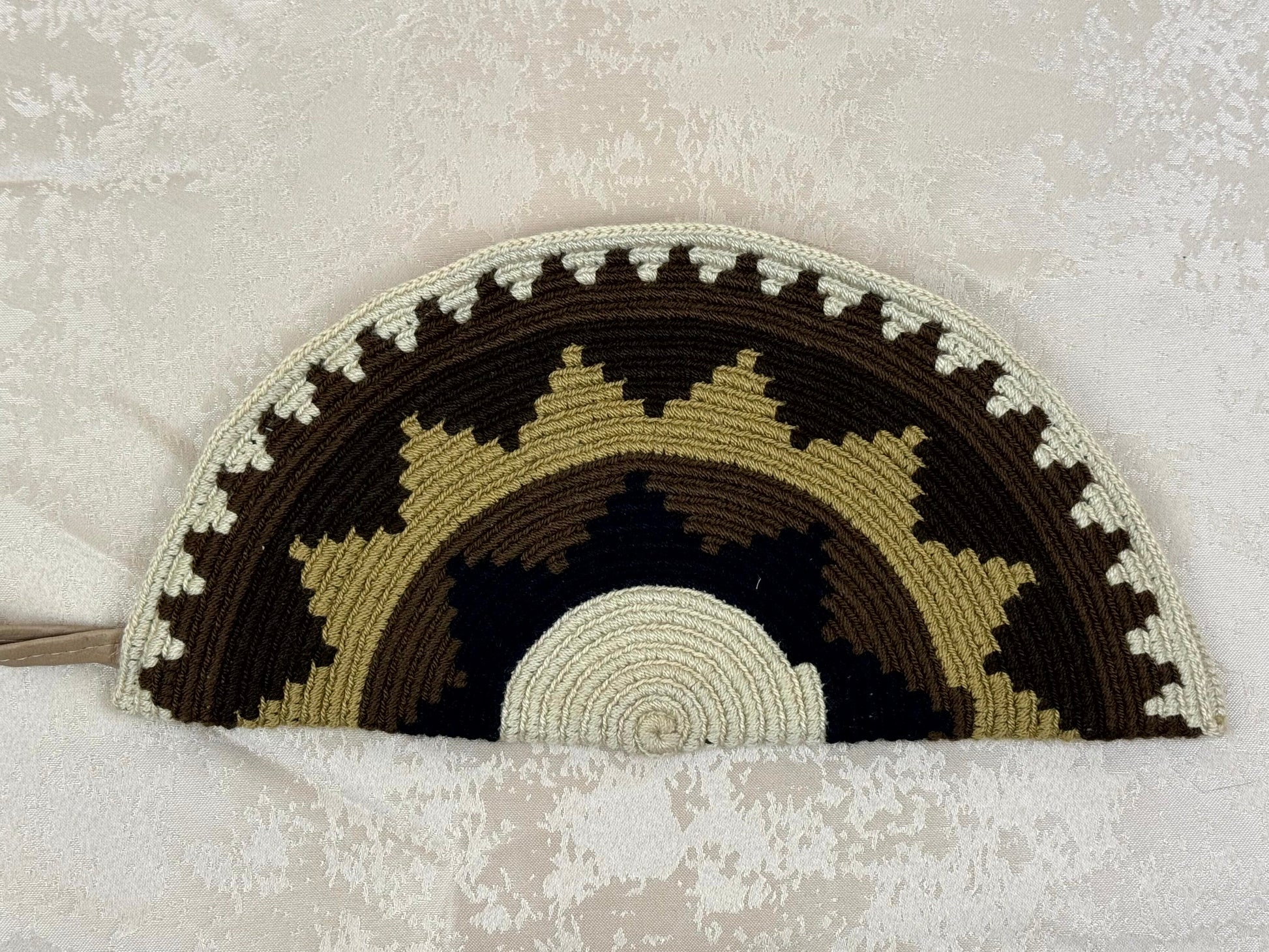 Crocheted rainbow pattern on a textured surface