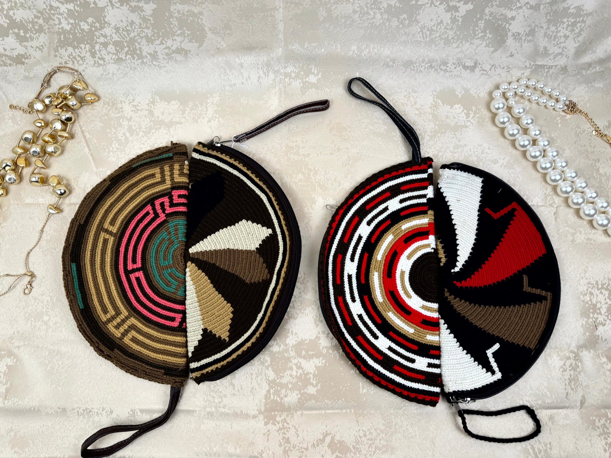 Two beaded coin purses with intricate patterns on a textured surface.