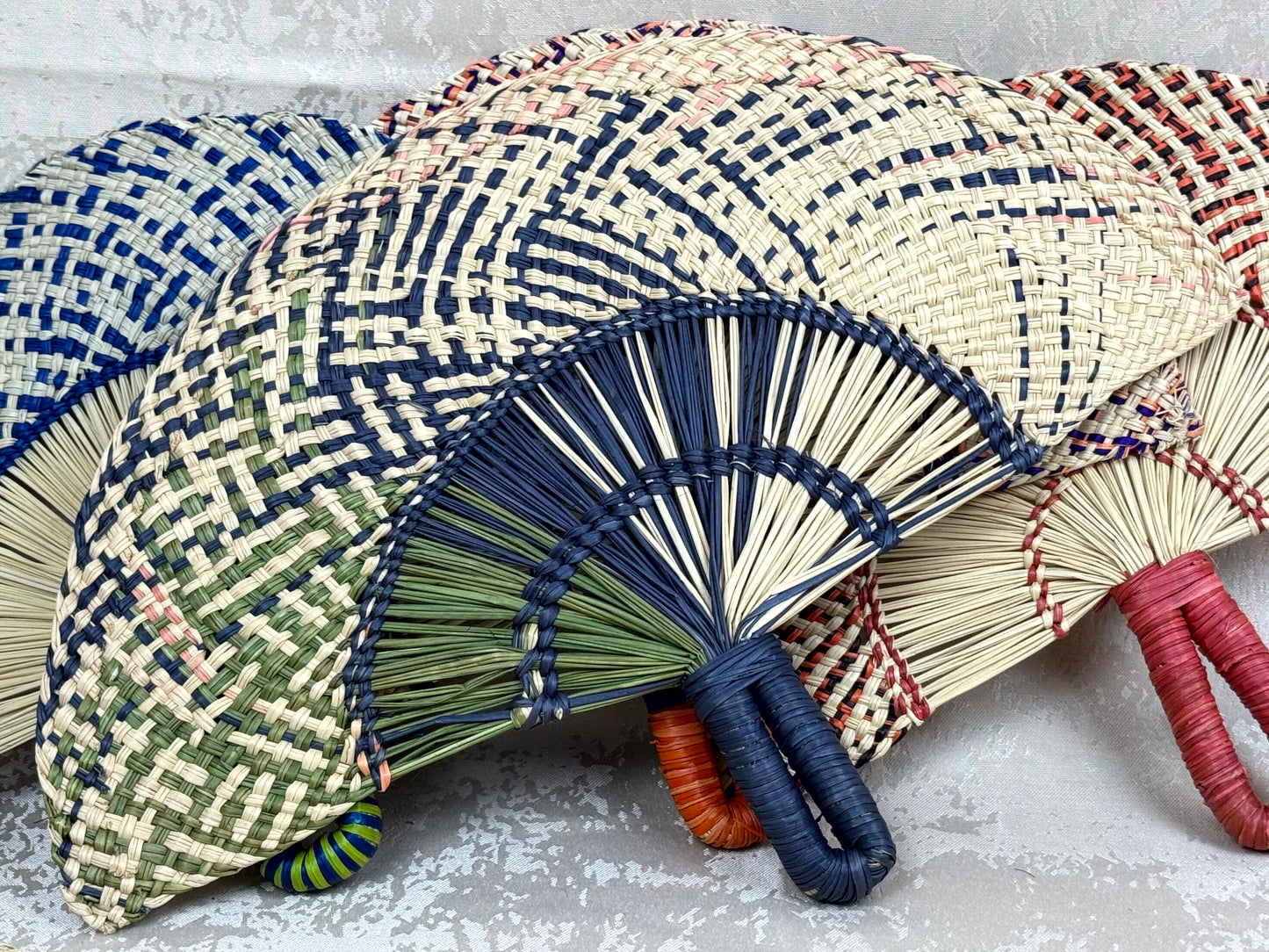 Abanico artesanal de iraca tejido a mano por artesanas colombianas con fibra natural de palma.